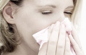 Woman blowing her nose